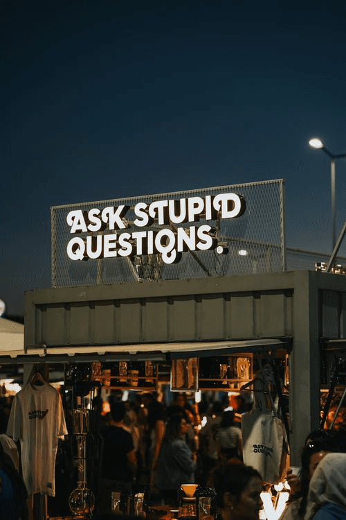 Illuminated large-format signage on a pop-up retail display at night